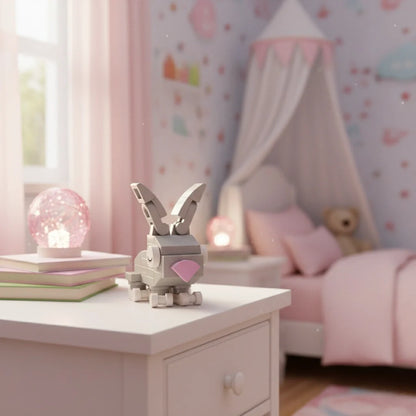 A cute Rabbit Building Block is placed on a white bedside table in a softly lit, pink-themed children's bedroom.